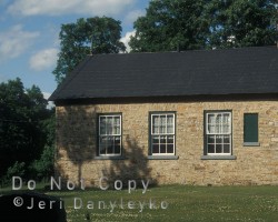 A side view of the former schoolhouse and cemetery building. Former school