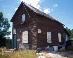 A former worker's home, probably occupied seasonally. This building has had some repair since. Home