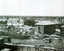 The mill tramway is in the foreground with the boarding house, Presbyterian Church and village in the background. Townsite