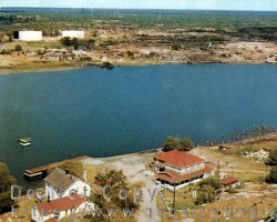 An aerial view of the Sawmill Lodge, likely photographed by H.R Oakman in the early 1960s. The mill ruins can be seen to the right of the lodge. Aerial