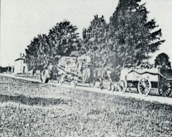 Threshing machine and water wagon in the hotel lot. ca. early 1900s Hotel lot