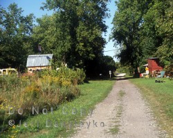 A roadway with a few rural structures. Roadway