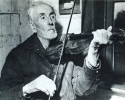 Thomas Bell, age 95, playing the violin he built himself Photo of resident