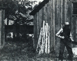Thomas Bell cutting wood Photo of homestead