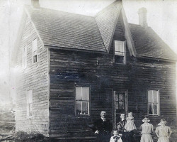 The Vickers family (second generation) in front of the original family home. ca. 1910.<br><br> Eliza (Vickers) Brown is pictured second from the right. The Brown family remained in the home until 1940 when they moved to another home further along the Orange Valley Road. The home remained vacant until 1947 when it was demolished.<br><br>This photo was featured on an historical plaque commemorating North Seguin. Family photo